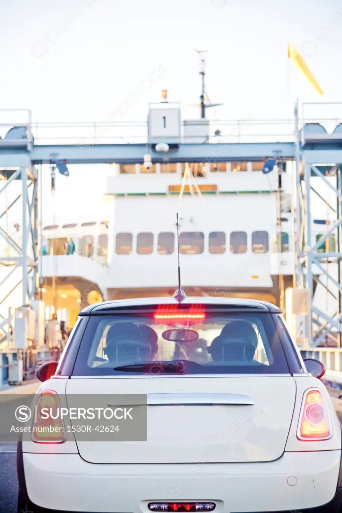 White car boarding ferry on puget sound