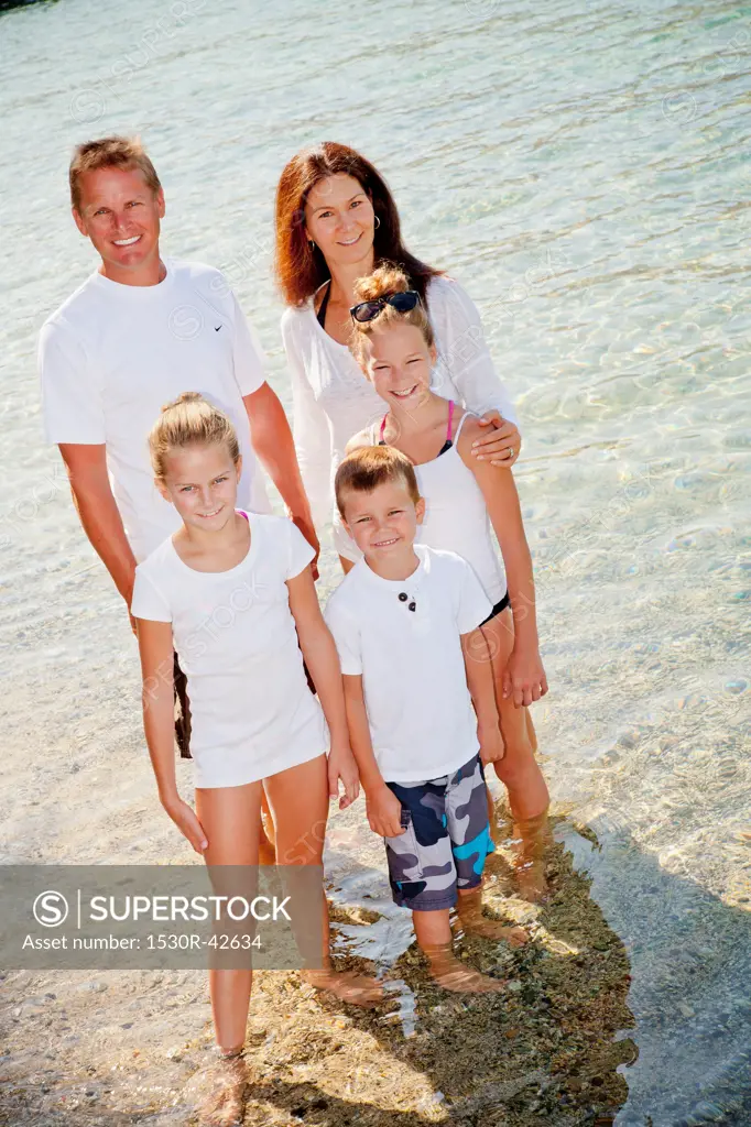 Family standing in shallow water