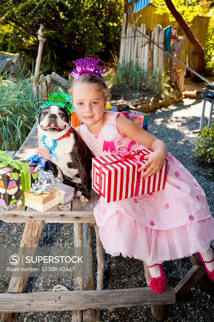 Young girl and dog at outdoor birthday paty