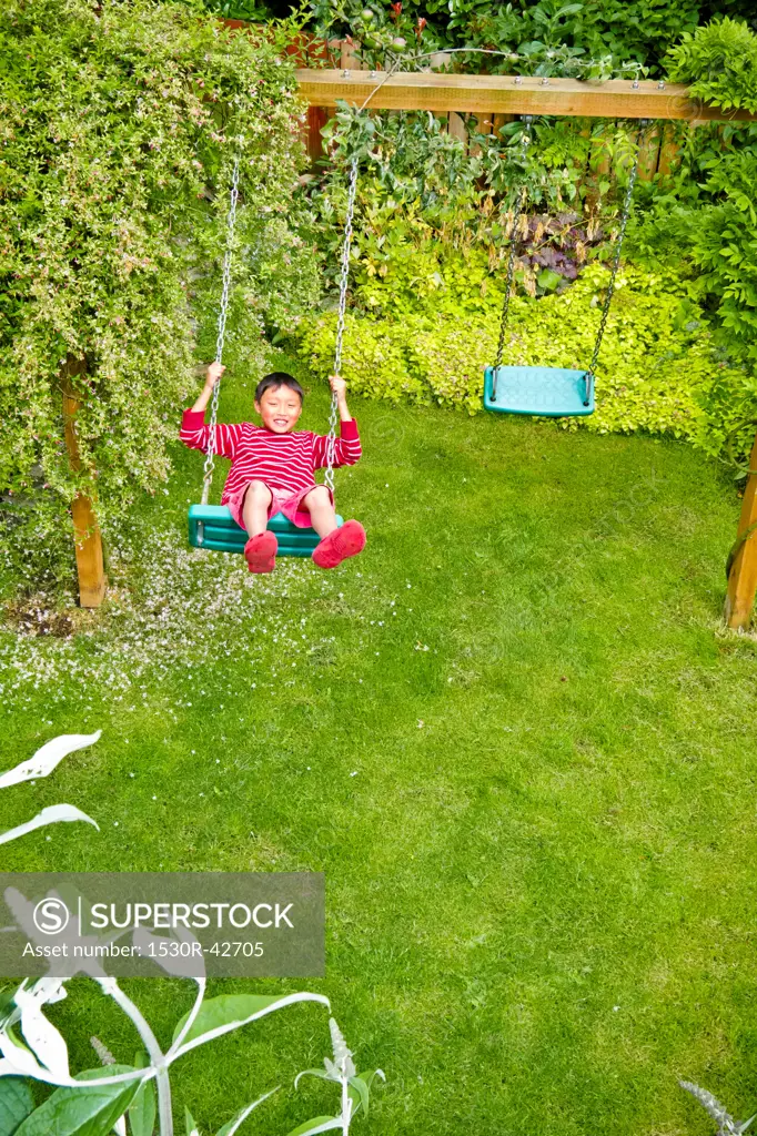Boy on backyard swing