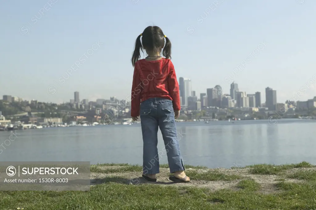 Young girl gazing at the Seattle skyline.