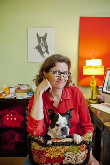 Woman at home office desk with dog