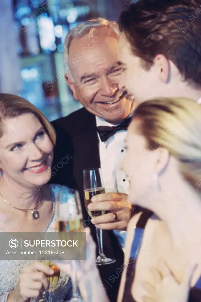 Senior couple standing with a young couple