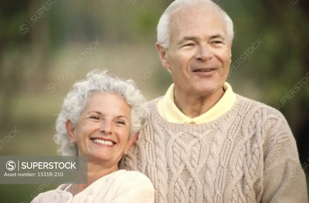 Senior couple looking ahead smiling