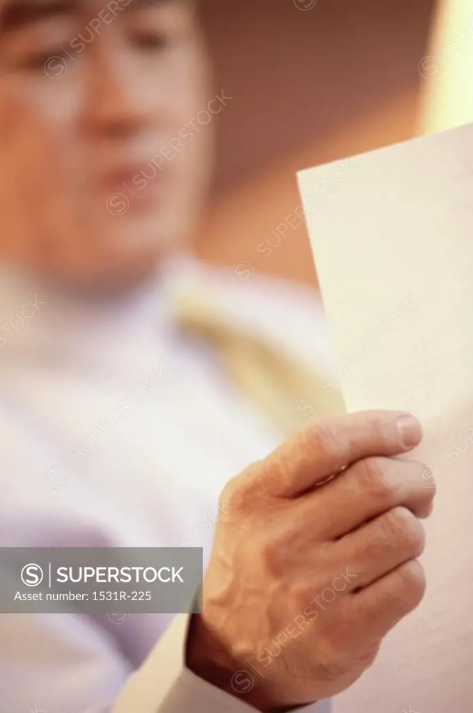 Businessman reading a sheet of paper