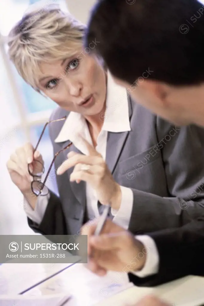 Businesswoman talking to a businessman