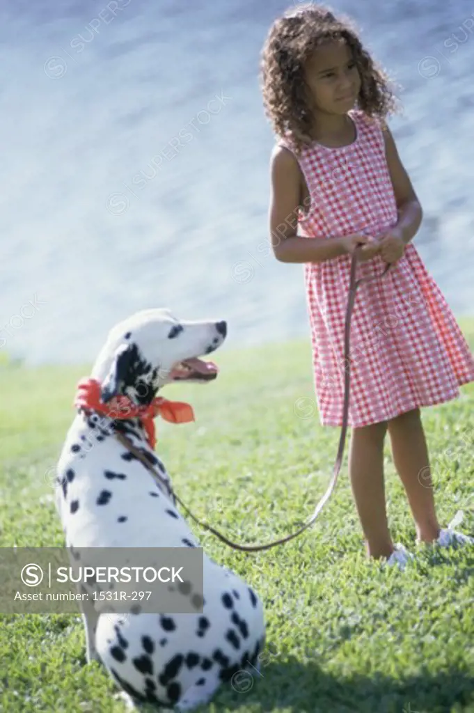 Girl standing with a Dalmatian