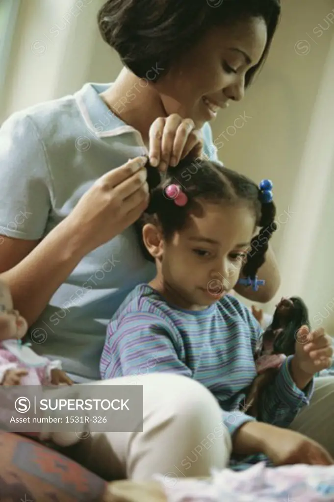 Mother styling her daughter's hair