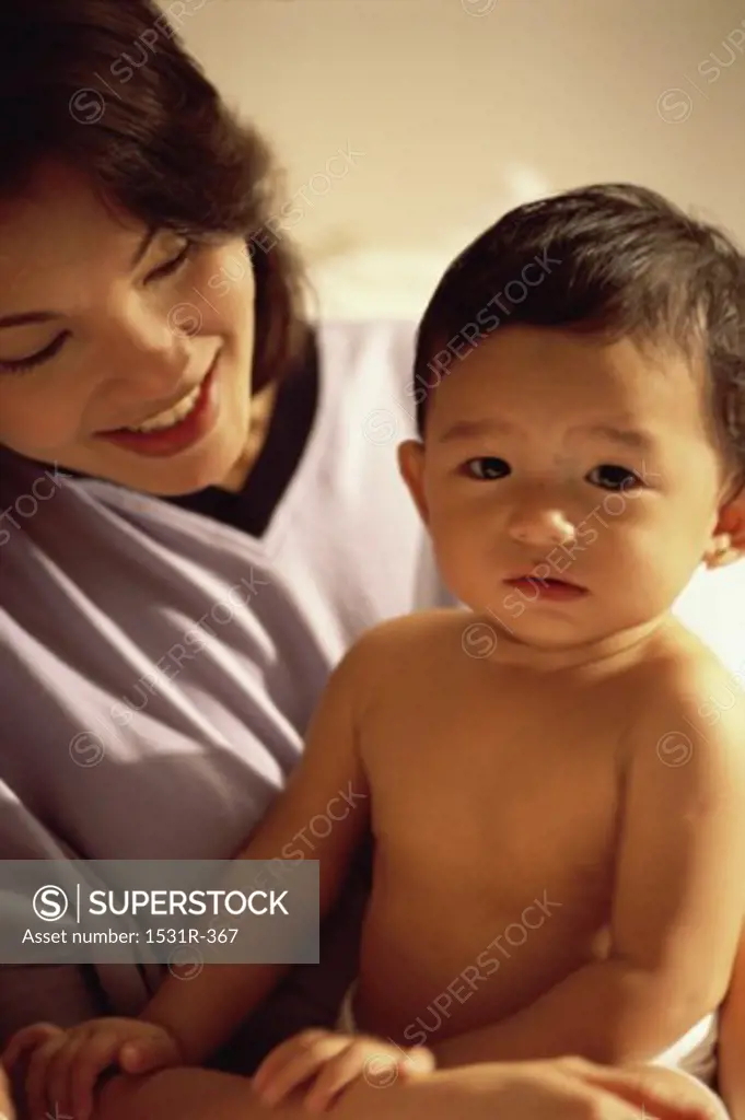 Portrait of a baby boy sitting with his mother