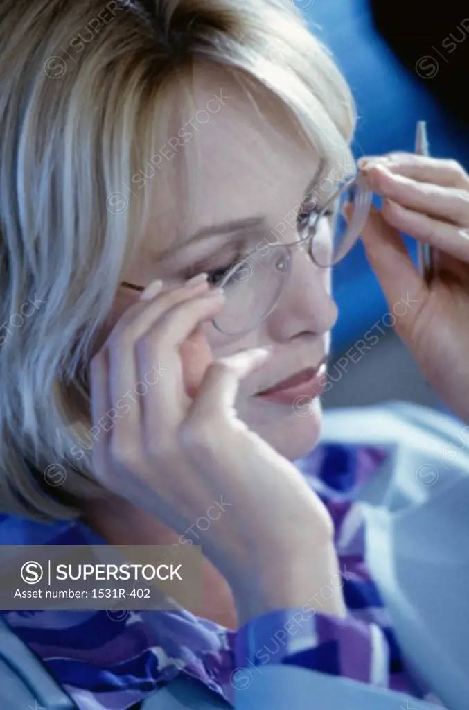 Businesswoman adjusting her eyeglasses