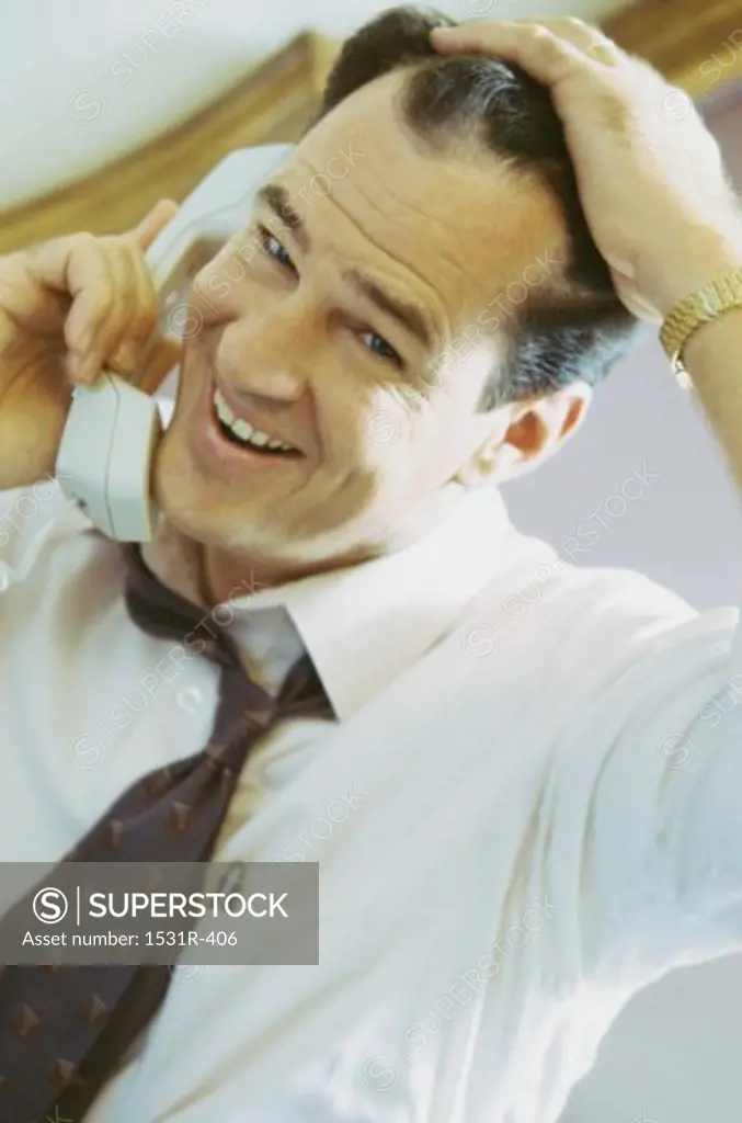 Portrait of a businessman talking on a landline telephone