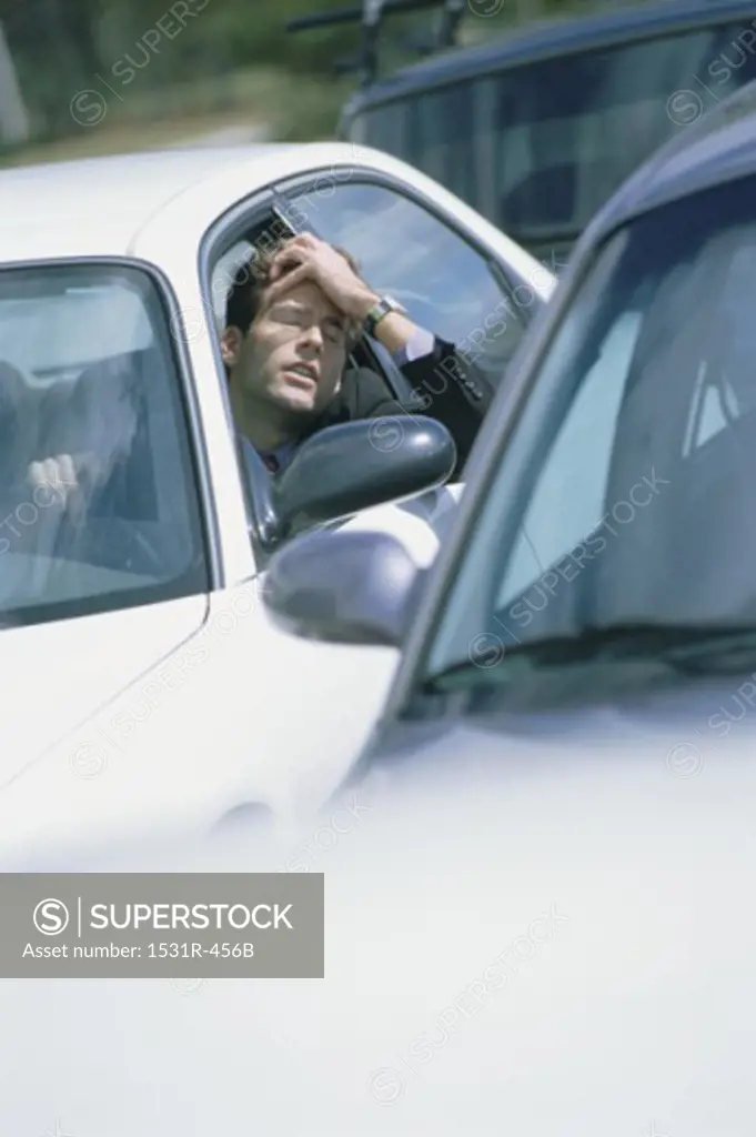 Man sitting in his car in traffic