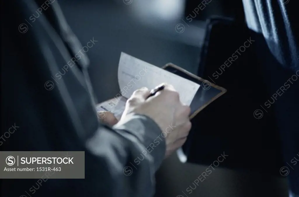 Person writing a check
