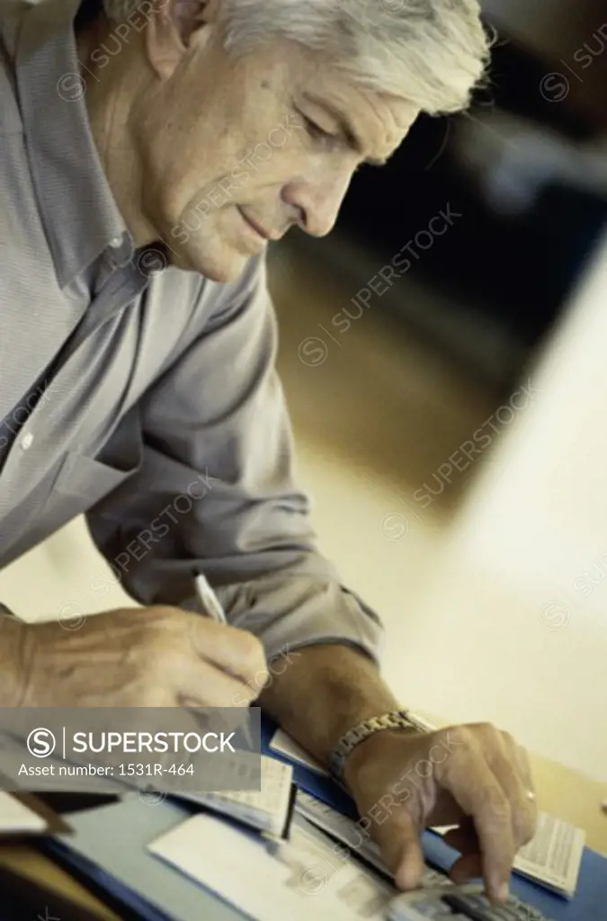 Side profile of a man writing a check