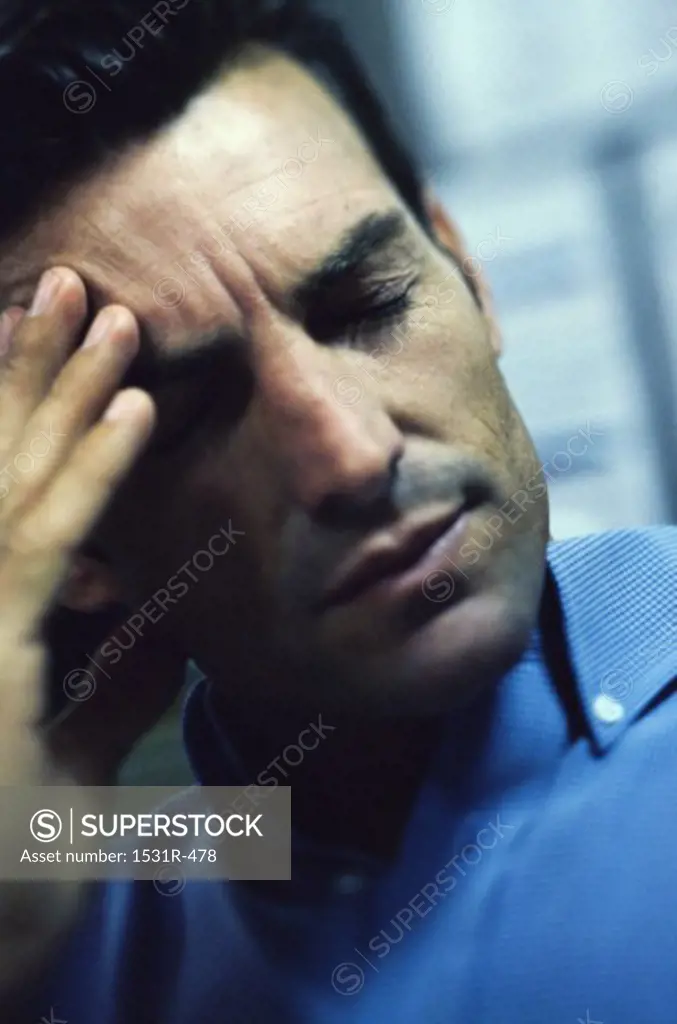Man holding his forehead in pain