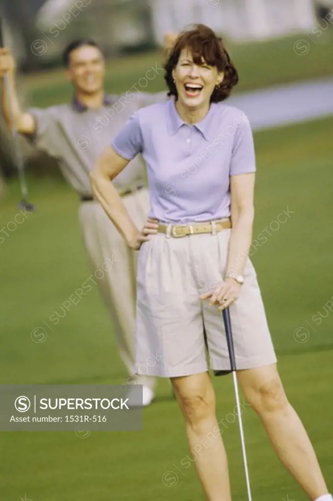 Mid adult man and a mid adult woman at a golf course