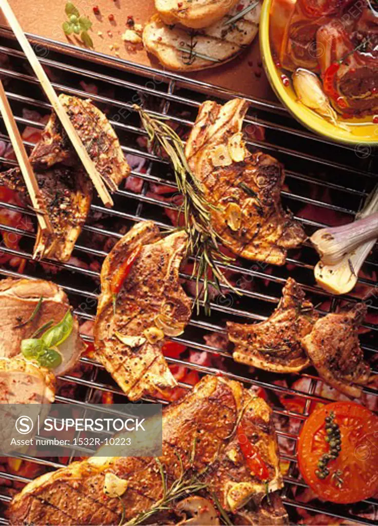 Grill rack with lamb cutlets and T-bone steaks