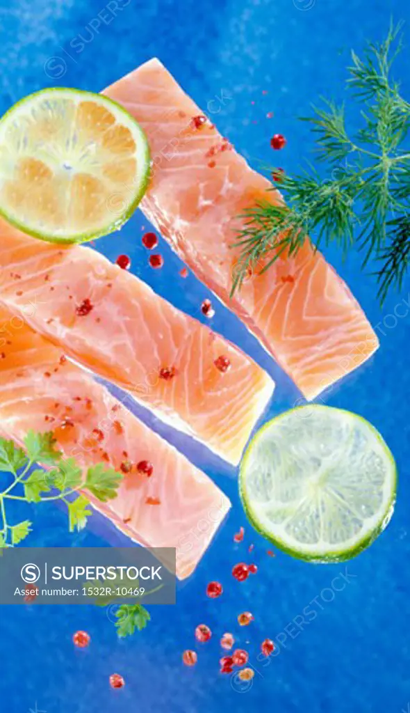 Several salmon fillets on blue background