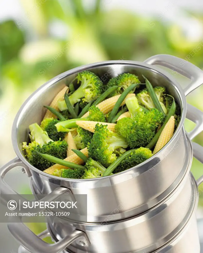 Broccoli, baby corn-cobs and green beans in steaming pan