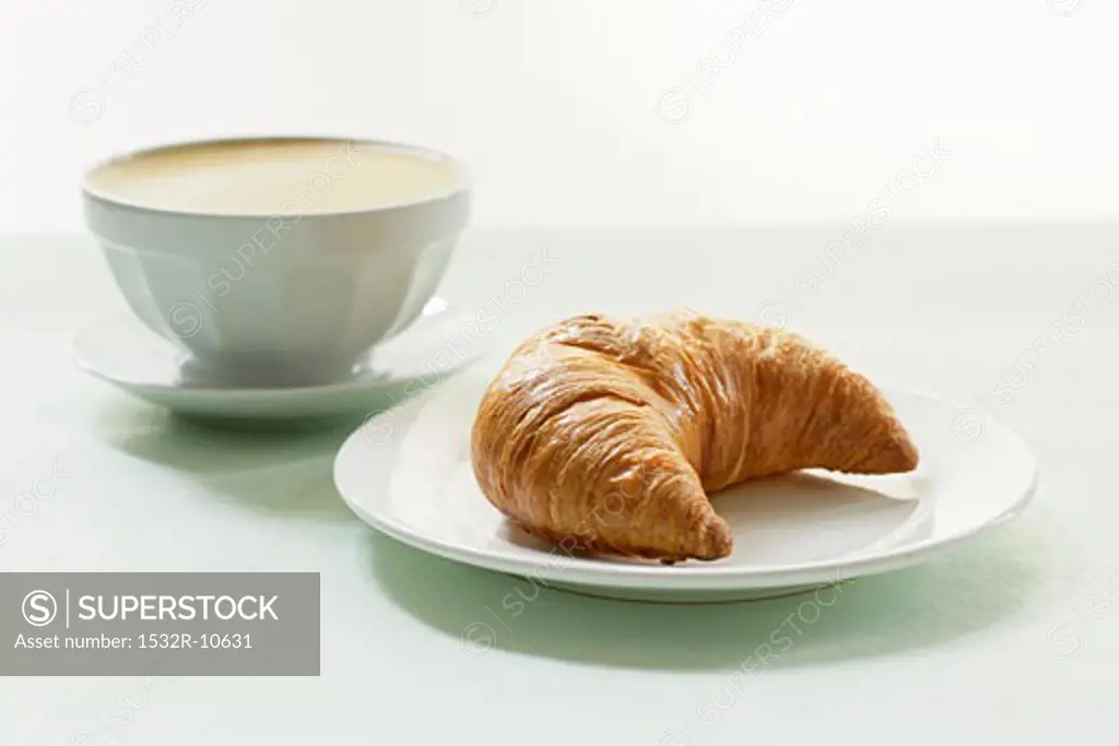 Milky coffee with a croissant