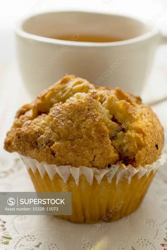 Muffin in front of a cup of tea