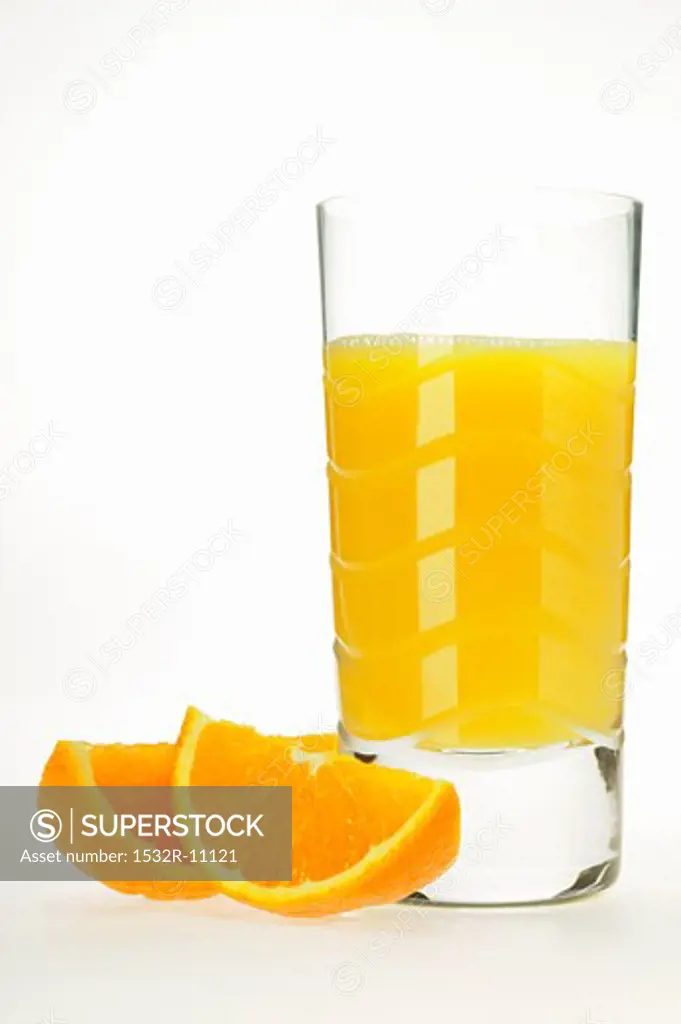 Glass of orange juice and two orange wedges (2)