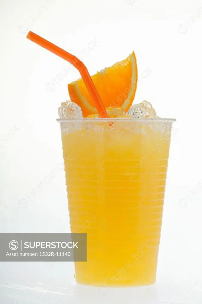 Orange juice with crushed ice, wedge of orange and straw