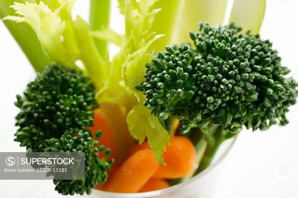 Celery, carrots and broccoli in glass (overhead view)