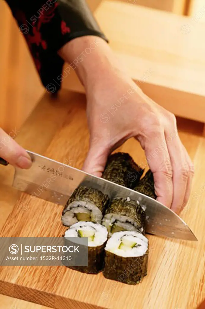Cutting rolled sushi into pieces (2)
