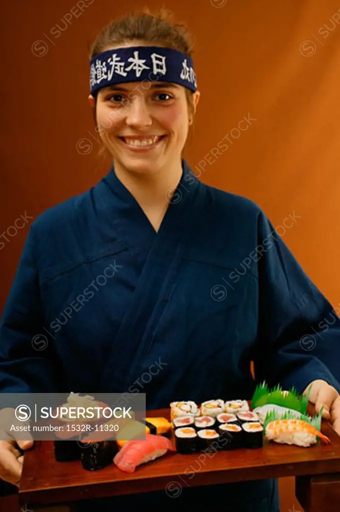 Woman serving sushi platter (1)