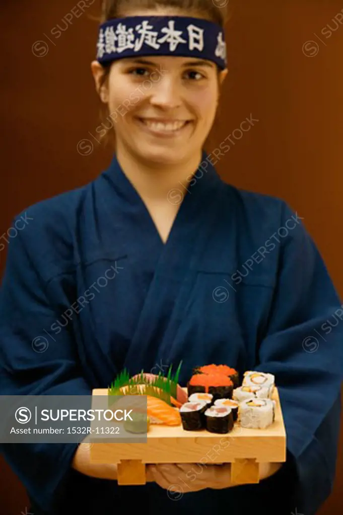 Woman serving sushi platter (2)