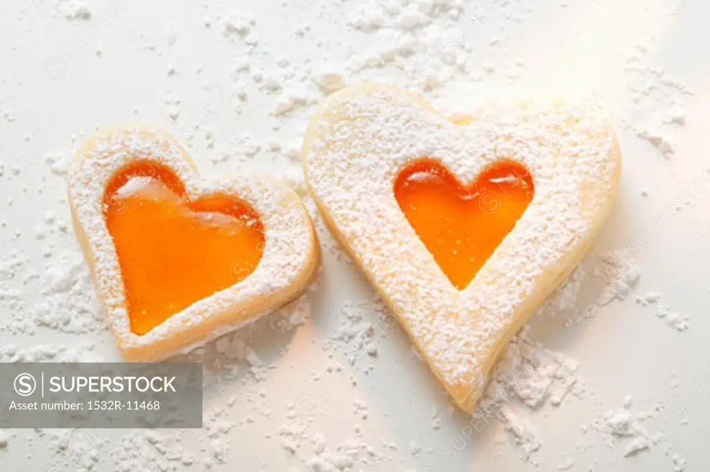 Sweet pastry hearts with apricot jam and icing sugar