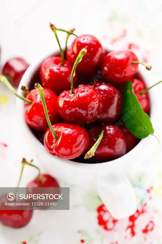 Fresh red cherries in beaker