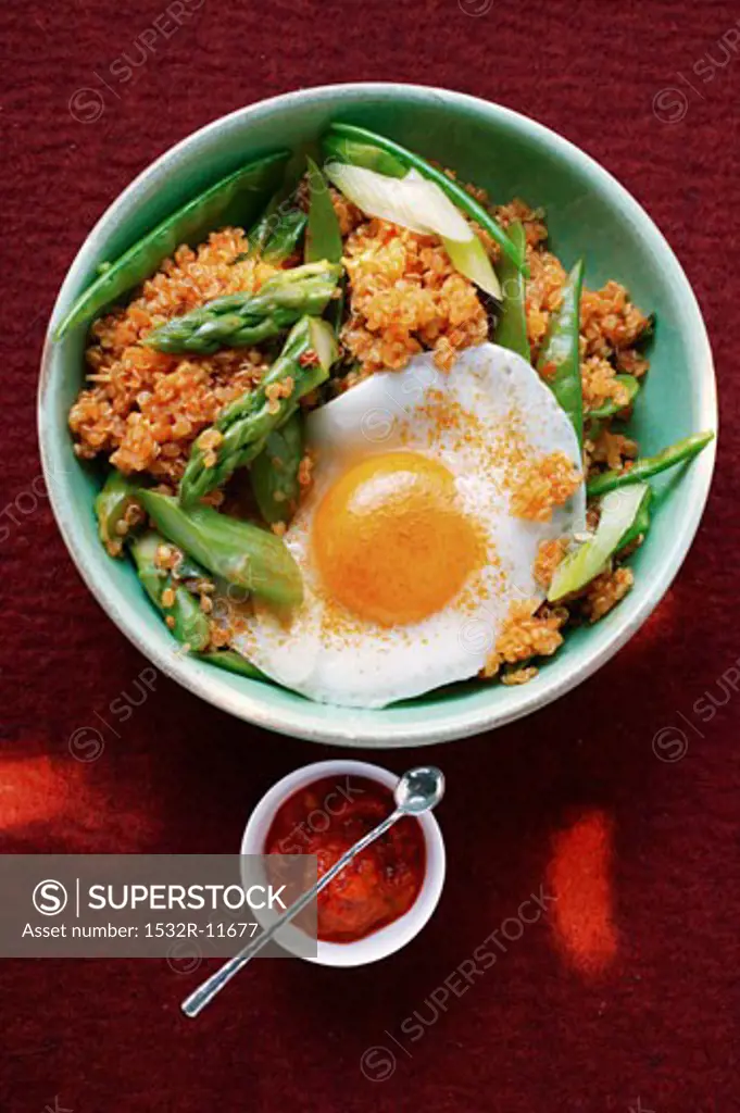 Quinoa with ajvar, green asparagus and fried egg