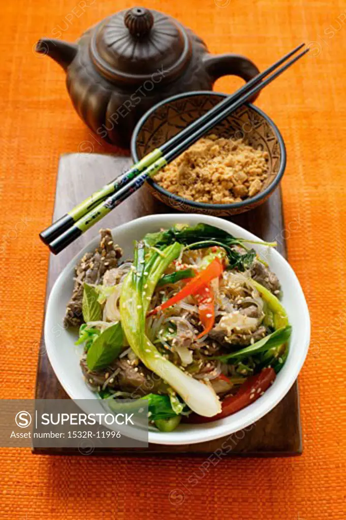 Glass noodles with beef and vegetables; chopped peanuts