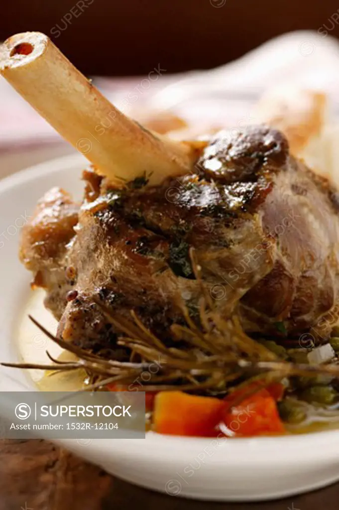 Braised lamb shank with vegetables & rosemary on plate