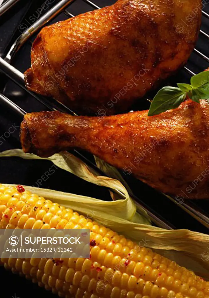 Chicken legs and corncob on the barbecue