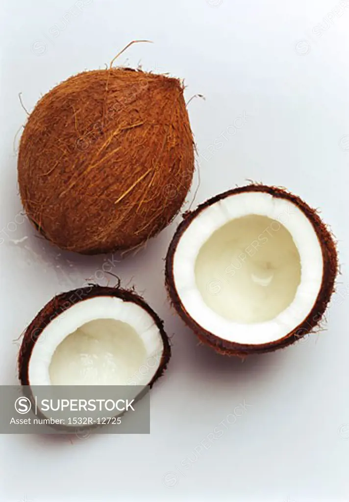 A whole coconut and two coconut halves