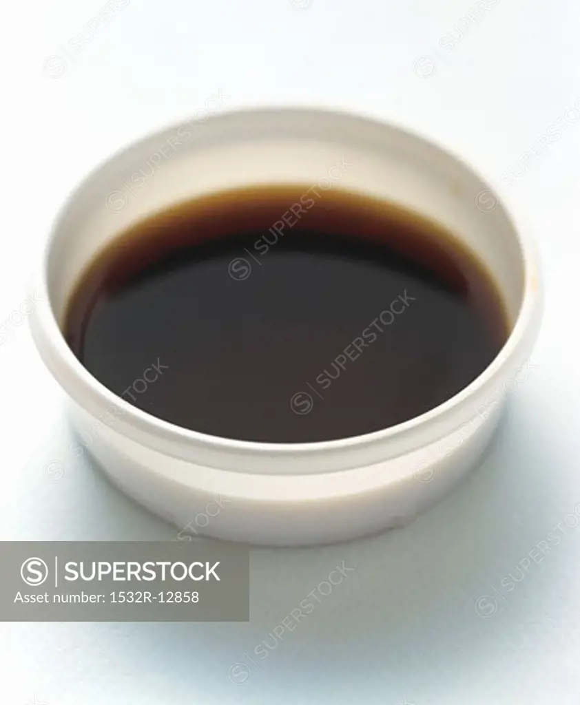 Soy Sauce in a White Plastic Container