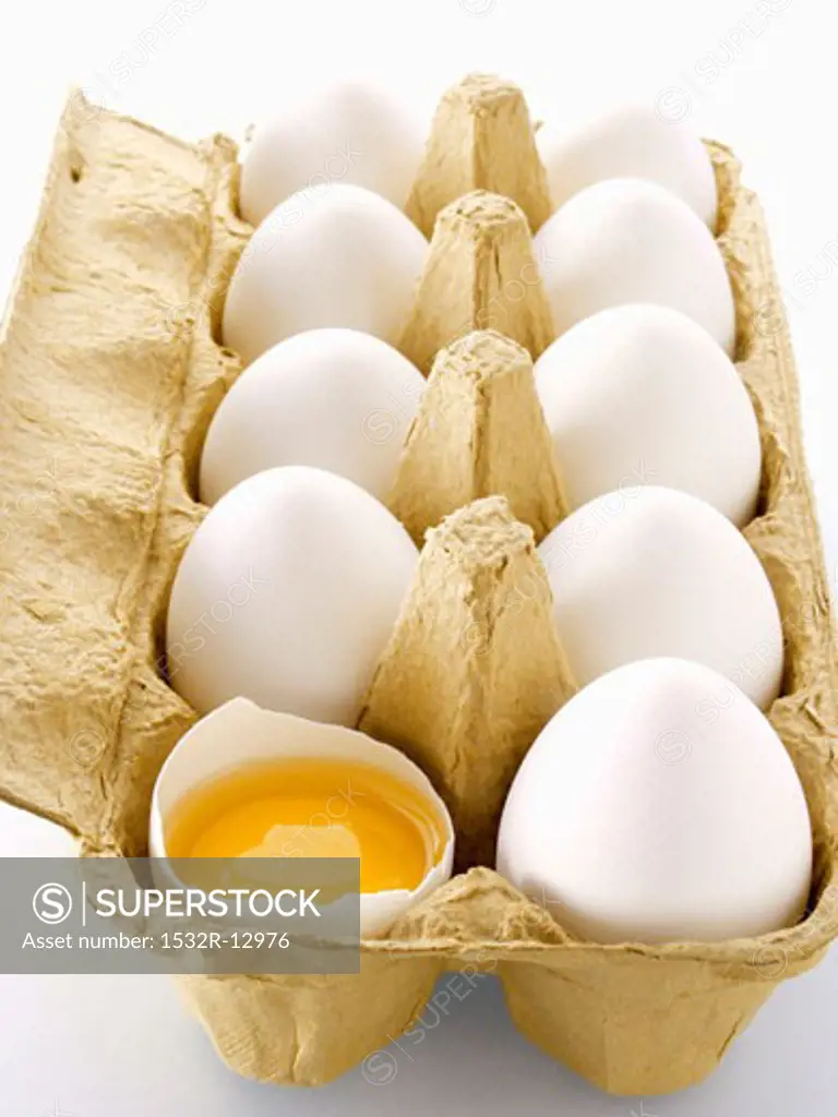 A Carton of Eggs with One Cracked Open