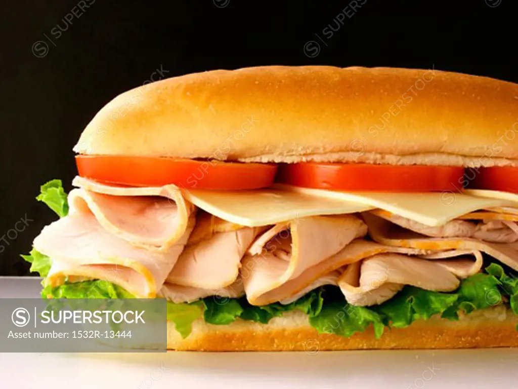 A Turkey Sub with Tomatoes, Cheese and Lettuce