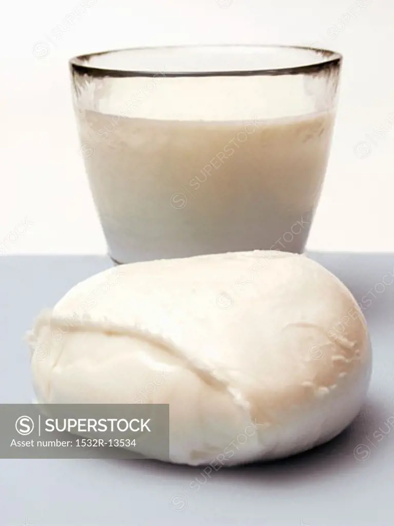 Two Balls of Mozzarella Cheese with a Glass of MIlk