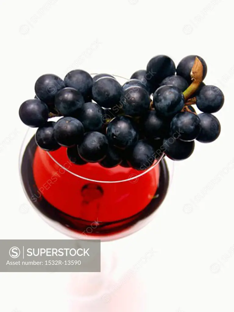 Grapes Resting on a Glass of Red Wine