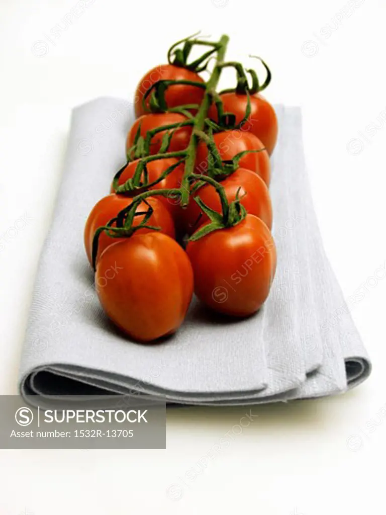 Vine Ripened Plum Tomatoes Resting on a Cloth