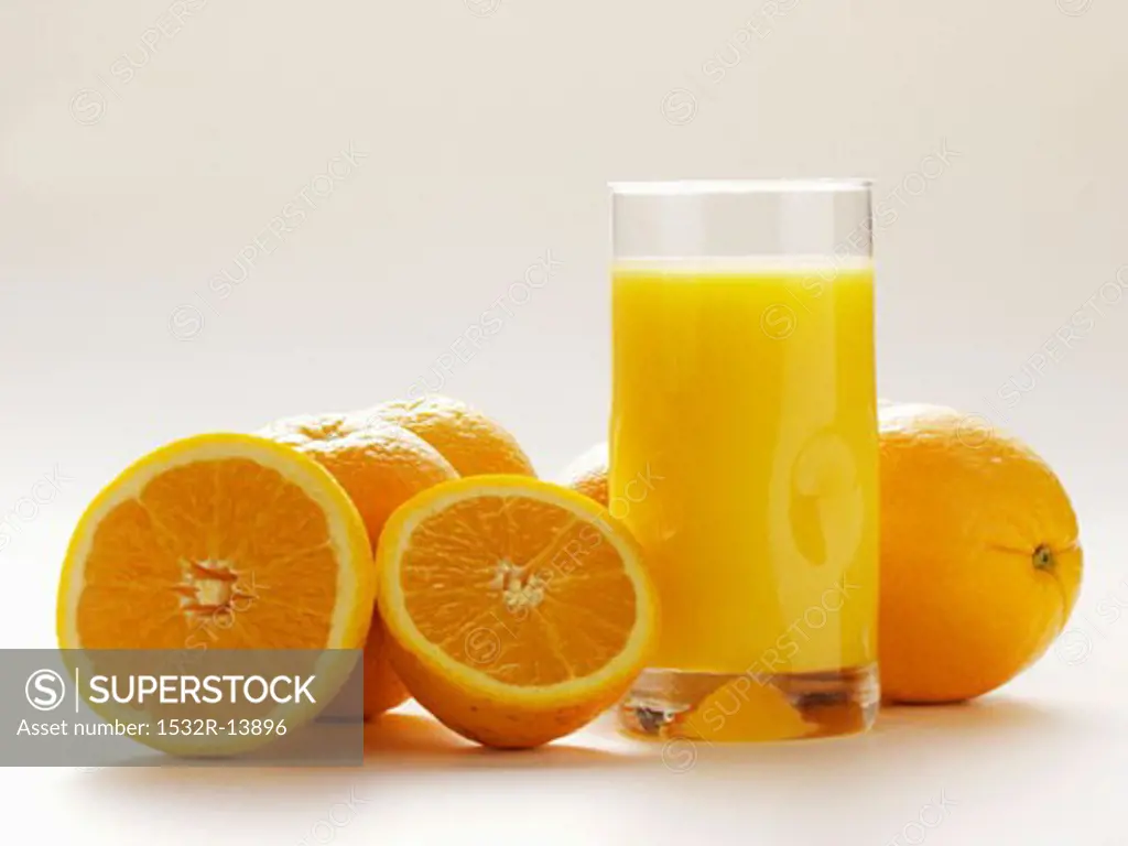 Glass of Orange Juice with Fresh Oranges