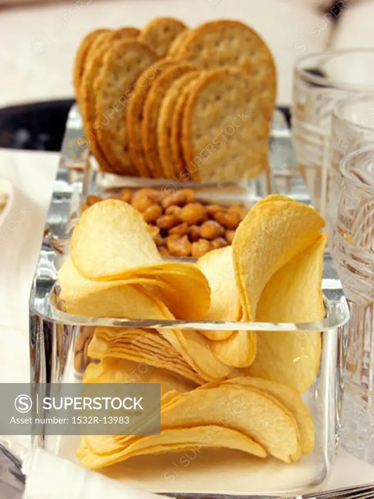 Cracker, Peanuts and Chips in Dishes