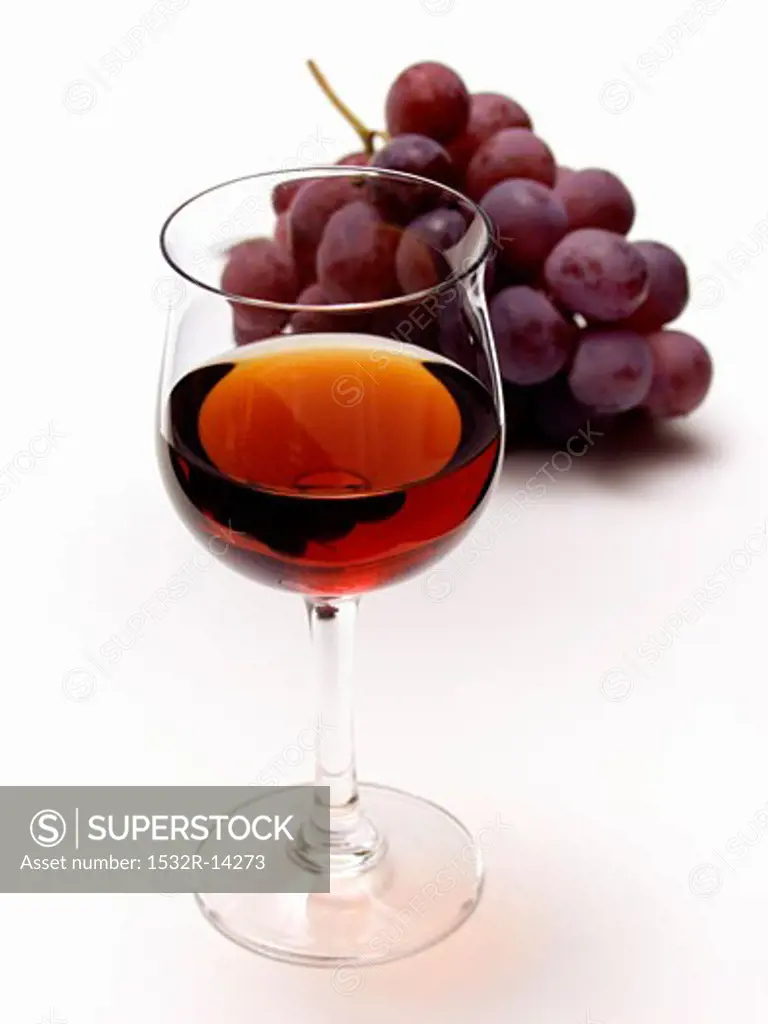 Glass of Red Wine with Red Grapes