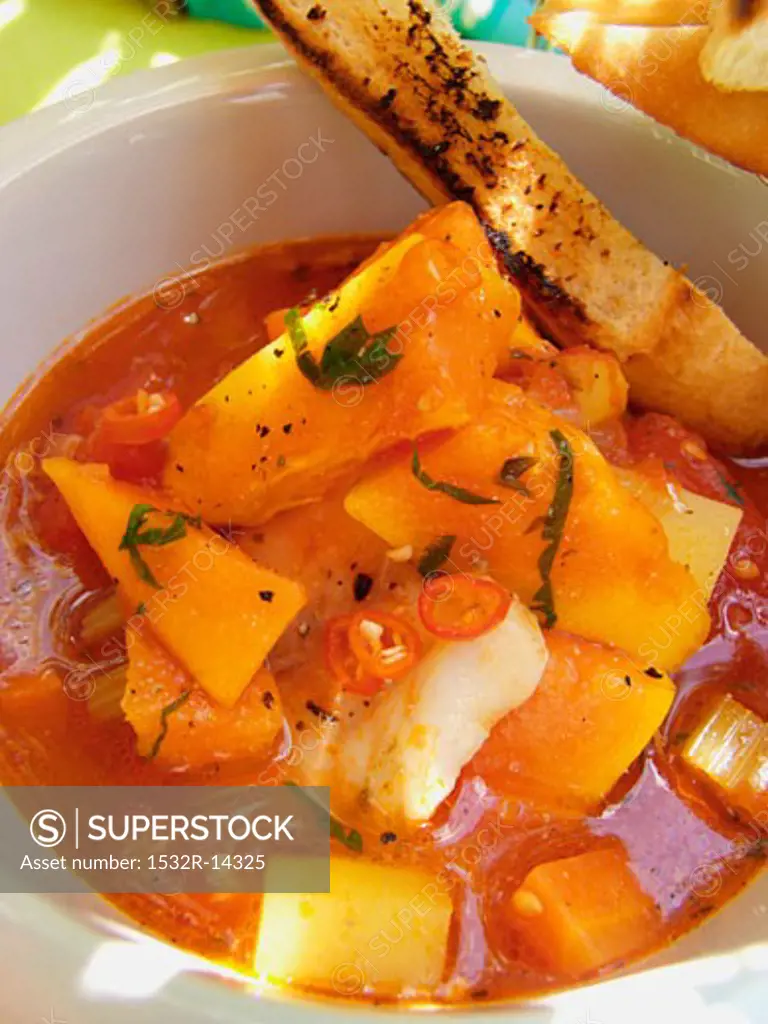Spicy Creole fish soup with sweet potatoes and chili