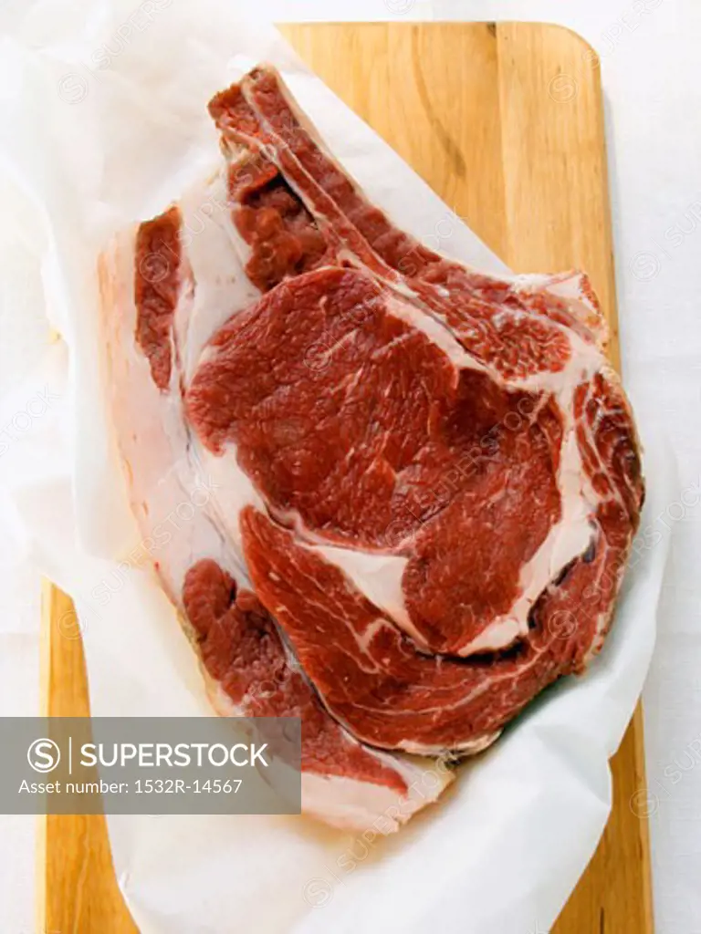Ribeye steak on chopping board
