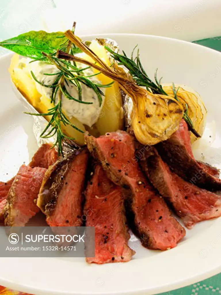 Beef steak with garlic, herbs and baked potato